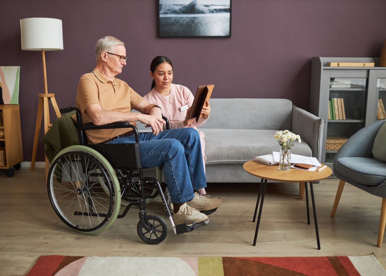 volunteer-helping-senior-man-use-tablet-pc